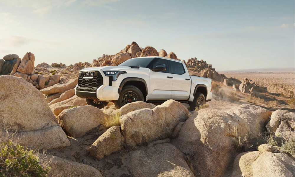 white toyota tundra off road on dirt terrain and rocks